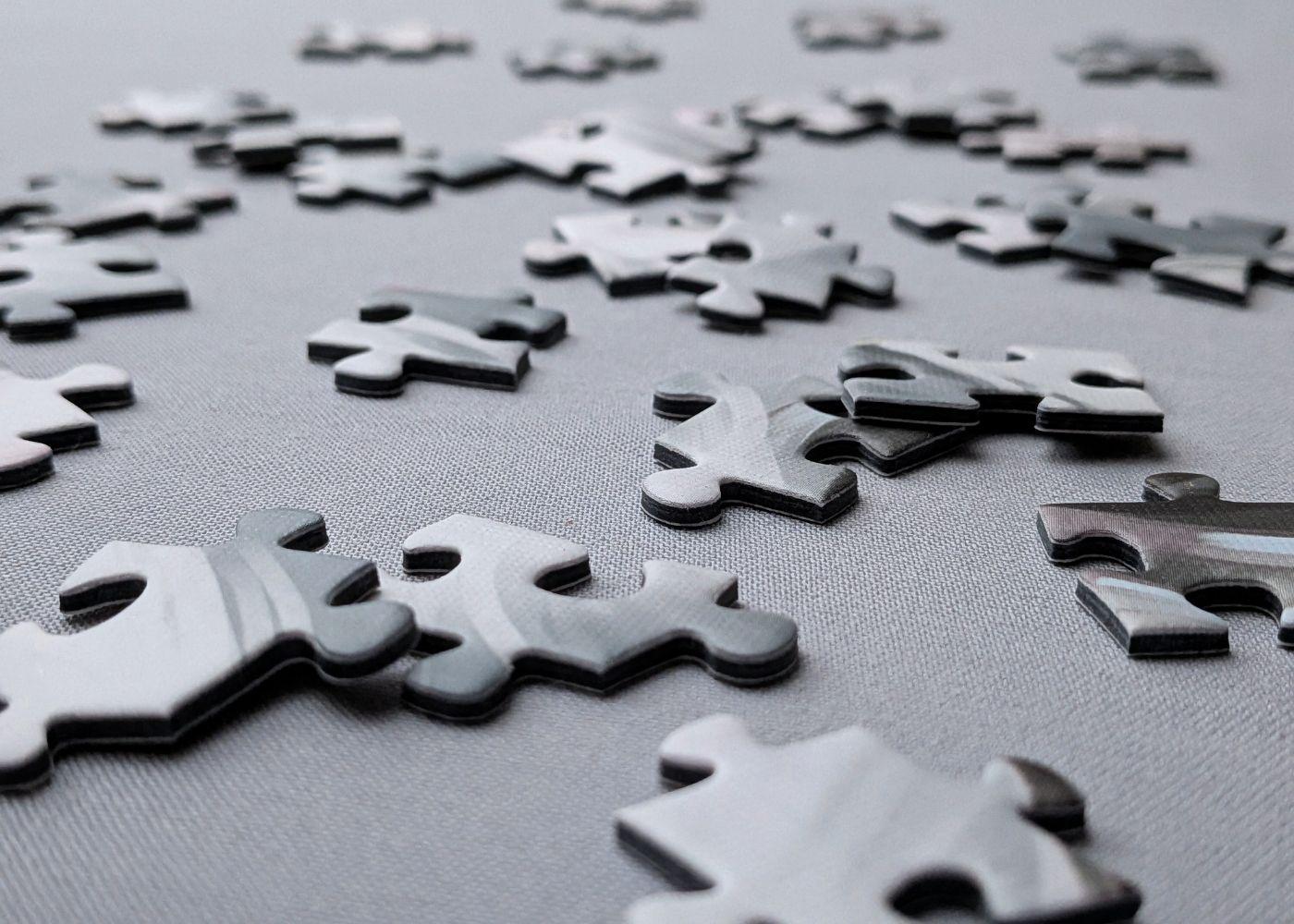 Scattered puzzle pieces side view